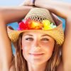 Woman with solar urticaria in sun wearing hat